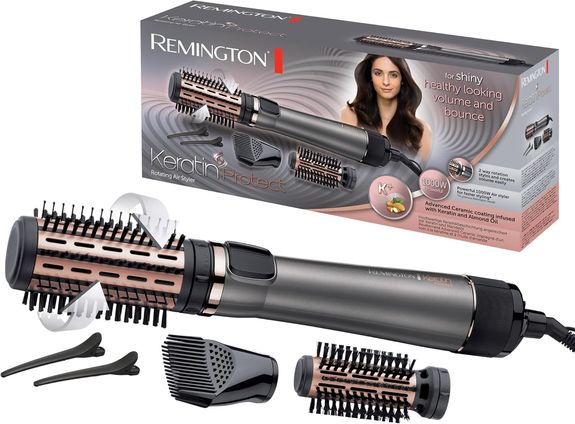 Remington Keratin Protect AS8811 Warmluftbürste mit alles Aufsätzen und dem Karton im Hintergrund 